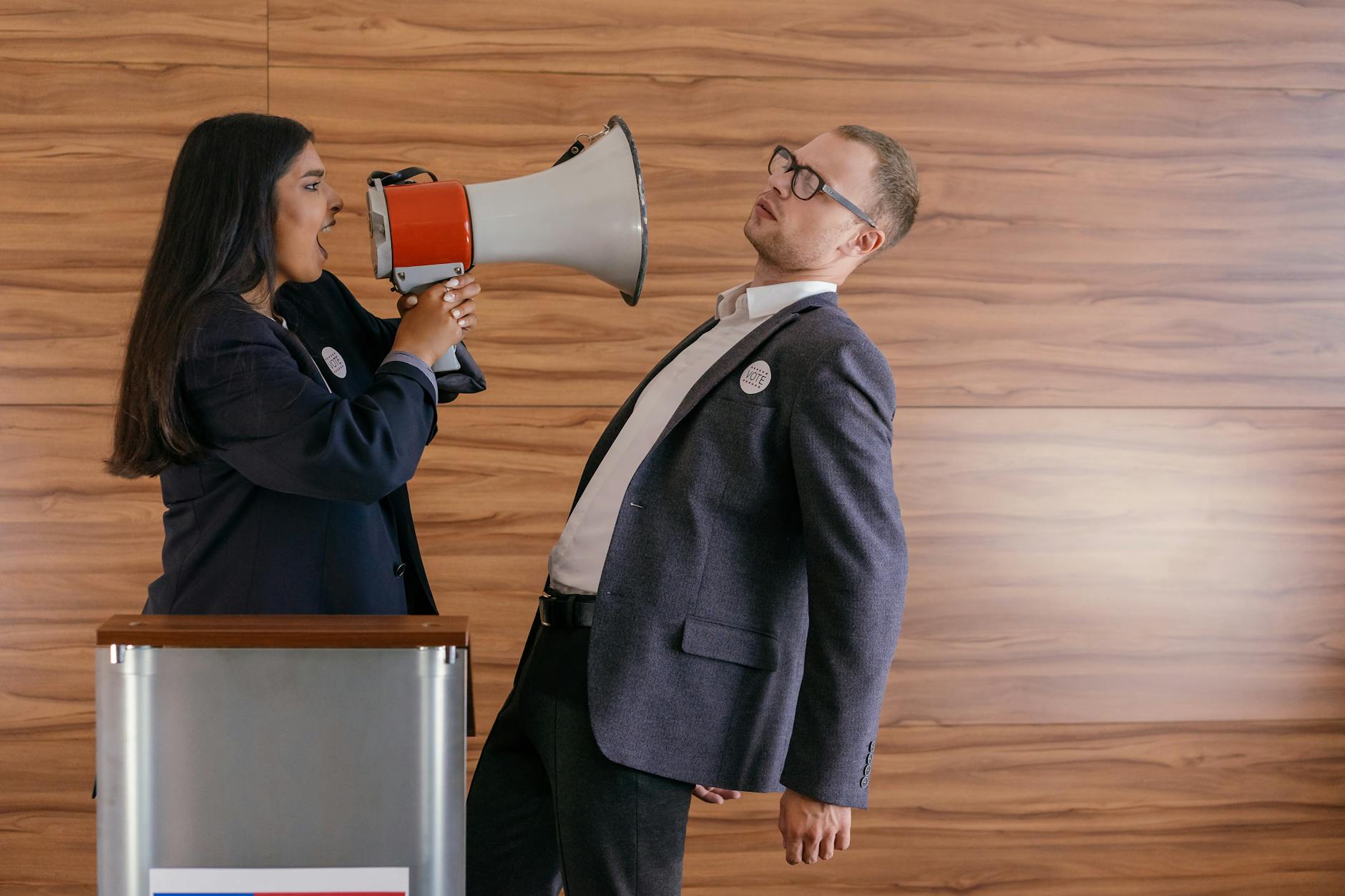 woman shouts on man using megaphone