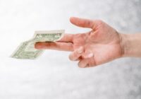 person holding one dollar bill